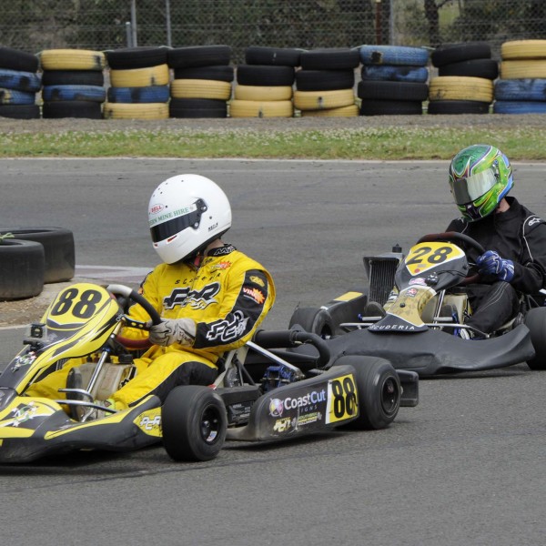 Two go-kart riders racing around the track