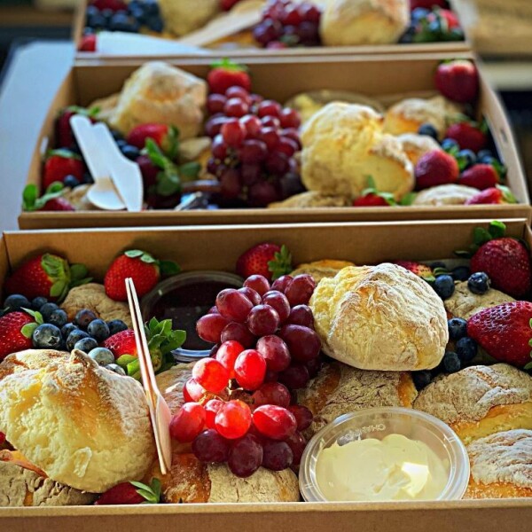 Small platter box full of fruit and baked goods