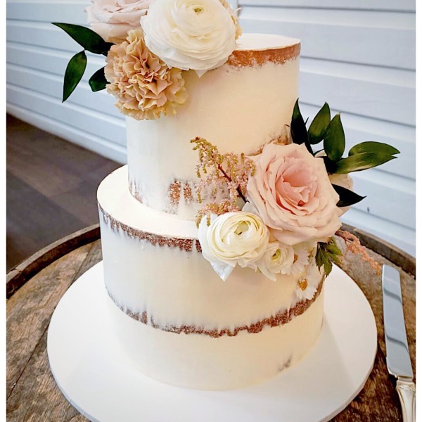 Two tier naked wedding cake with pink florals