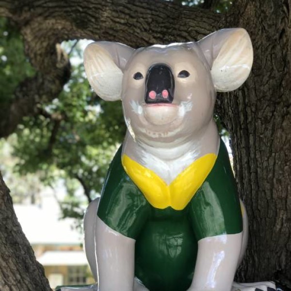 Green and gold Koala artwork in the trees