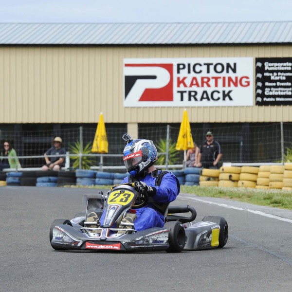 Man wearing blue racing suit practicing laps around Picton Karting Track