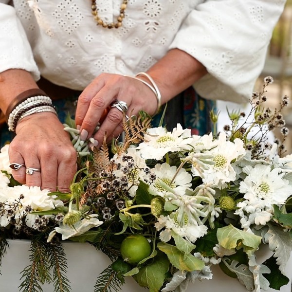 Native florals being made into an arrangement