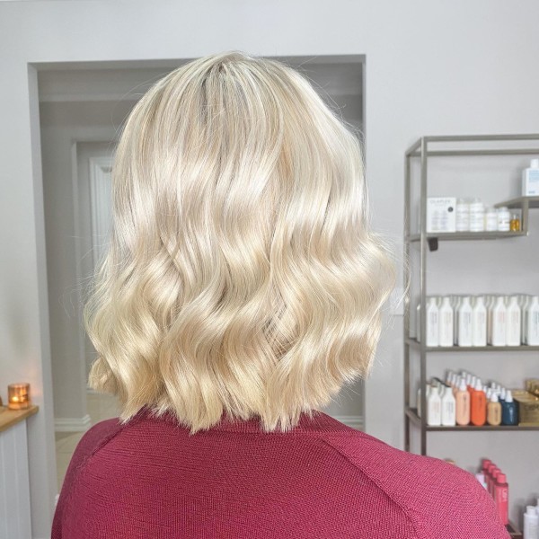 Lady with short blonde wavy hair