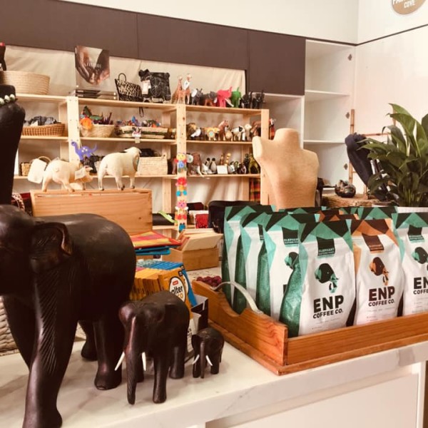 Wooden elephants and ethically sourced coffee beans on counter top