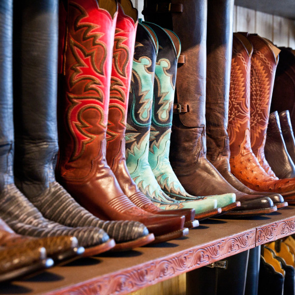 Row of colourful cowboy boots on retail shelf