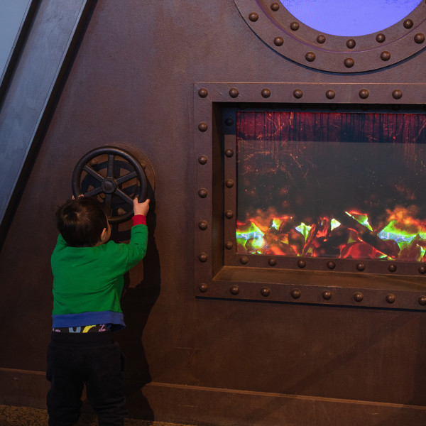 Little boy playing with interactive displays at NSW Rail Museum