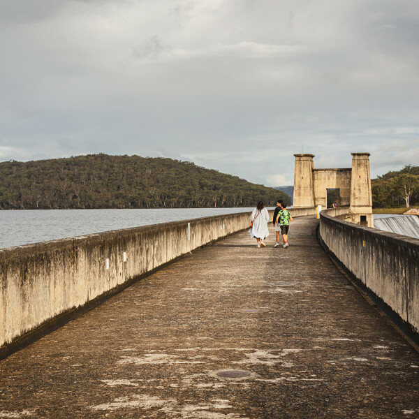 People walking Cordeaux Dam Wall