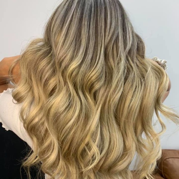 Client from Argyle Hair Design with fresh blonde curls
