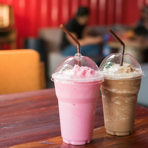 Two milkshakes on a table