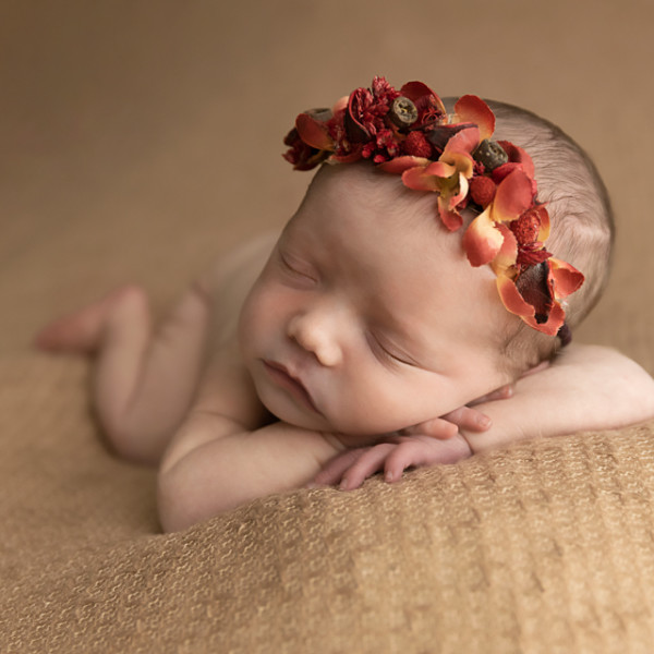 Newborn baby asleep with flower crown