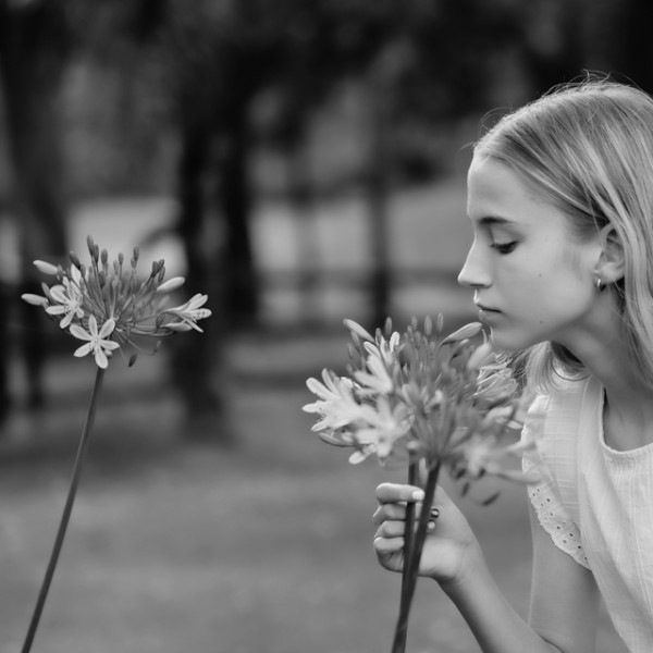 Black and white photo of girl with flowers