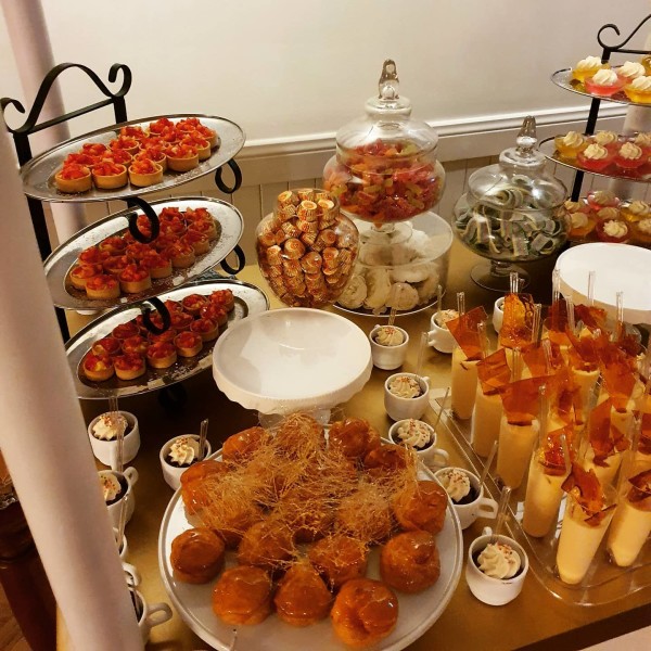 Table with lots of desserts presented on platters at Appin House