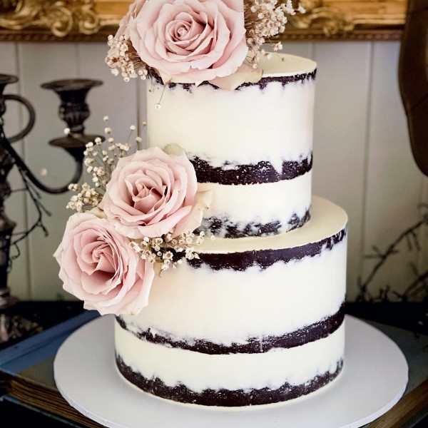 Naked wedding cake design with simple pink florals