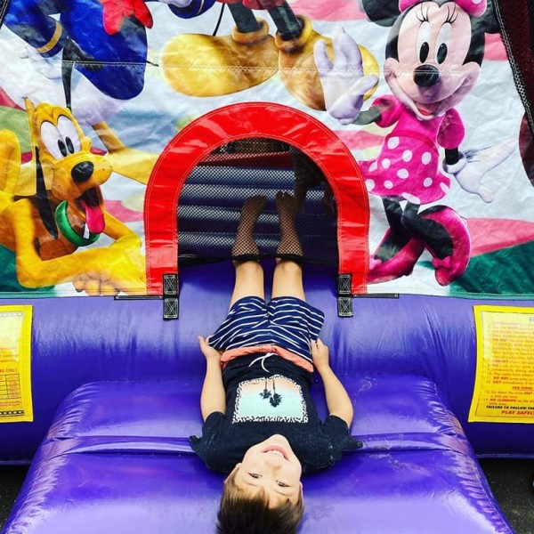 Boy playing on Disney themed jumping castle