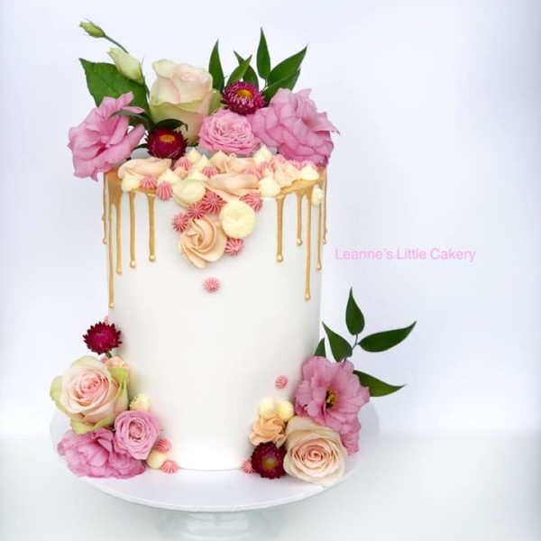 Wedding Cake with flowers and drip icing in gold
