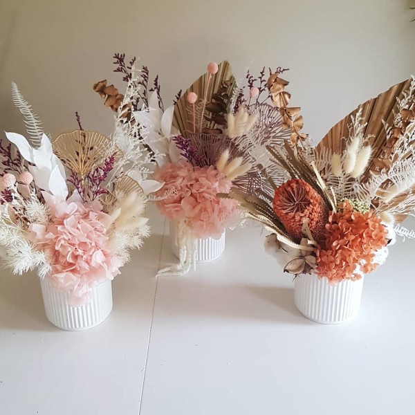 Small vases of dried florals